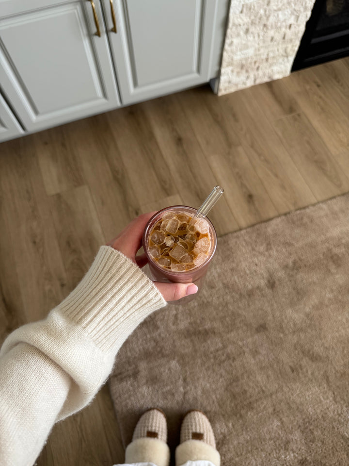 Iced coffee with a glass straw at home