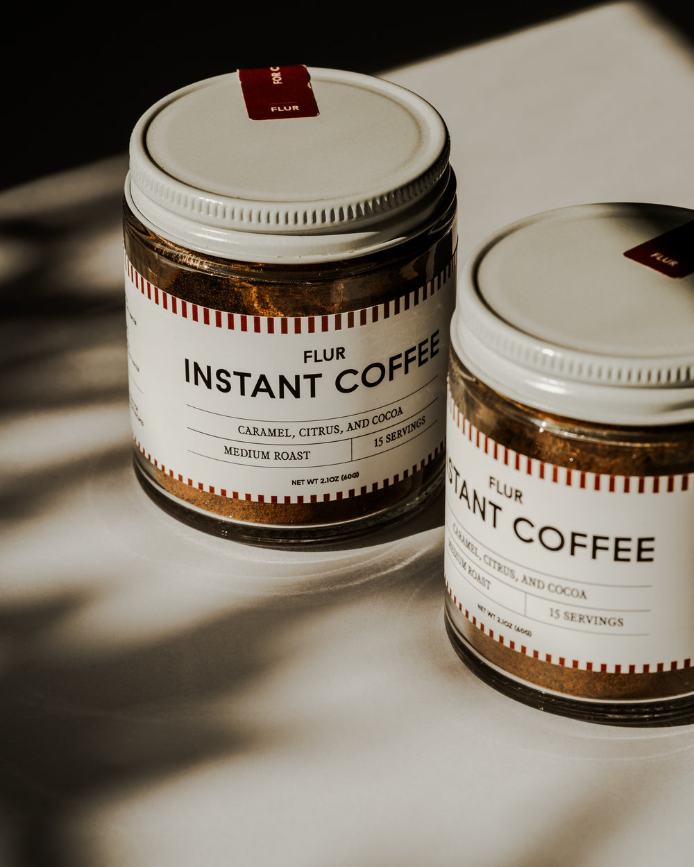 FLUR Instant Coffee jars in dappled light
